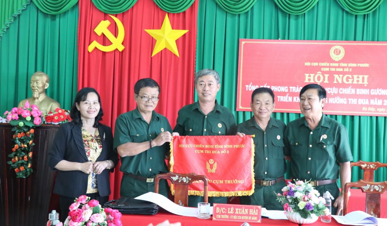 Ông Huỳnh Văn Nước, Chủ tịch Hội CCB tỉnh trao cờ luân lưu cho  Hội CCB huyện Bù Đốp làm cụm trưởng cụm thi đua số 2 năm 2021.